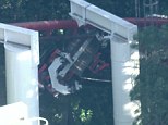 Oh no: Four people were injured tonight and 30 were stuck upside down when a roller coaster at Six Flags in Los Angeles derailed, pictured