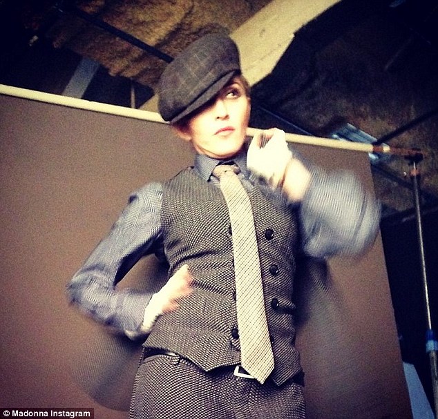 'Working Armani For. L'Uomo Vogue! #artforfreedom': The day after, the singer posted a behind the scenes photo to Instagram that showed her clad in a three-piece suit, complete with pageboy cap, as she embraced her androgynous side for the Italian men's magazine