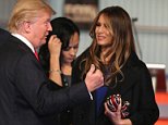 MILWAUKEE, WI - NOVEMBER 10:  Presidential candidate Donald Trump talks his wife Melania after the Republican Presidential Debate sponsored by Fox Business and the Wall Street Journal at the Milwaukee Theatre November 10, 2015 in Milwaukee, Wisconsin. The fourth Republican debate is held in two parts, one main debate for the top eight candidates, and another for four other candidates lower in the current polls.  (Photo by Scott Olson/Getty Images)