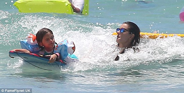 Fun in the sun: Anja and Alessandra play on boogie boards in the sea